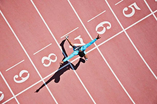 Φωτογραφία Runner crossing finishing line on track, Paul Bradbury