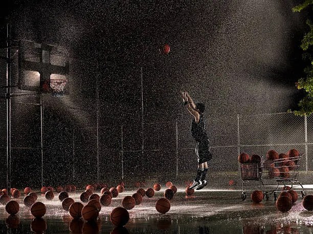 Φωτογραφία Man shooting basketball at night in, Adam Weiss